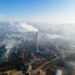 Aerial drone view of Chisinau. Thermal station with smoke coming out of the tube. Buildings and roads. Fog in the air. Moldova